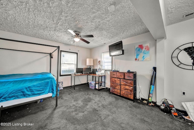 bedroom with visible vents, baseboards, carpet, a textured ceiling, and a ceiling fan