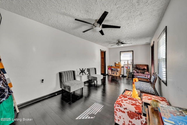 living area featuring a textured ceiling, a ceiling fan, and wood-type flooring