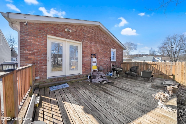 wooden deck with area for grilling and fence