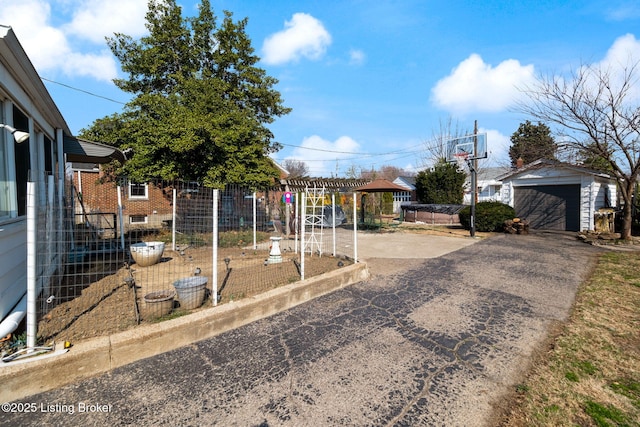 view of yard with a garage, central AC unit, and an outdoor structure