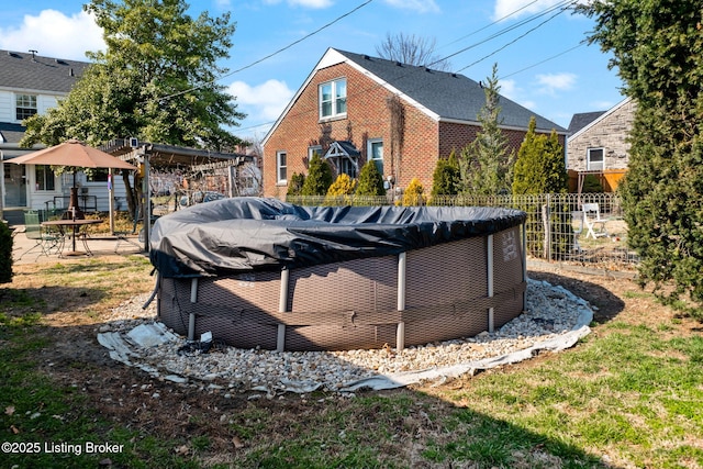 exterior space featuring a covered pool and fence