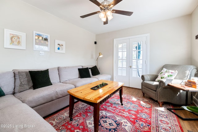 living room featuring french doors, wood finished floors, and ceiling fan