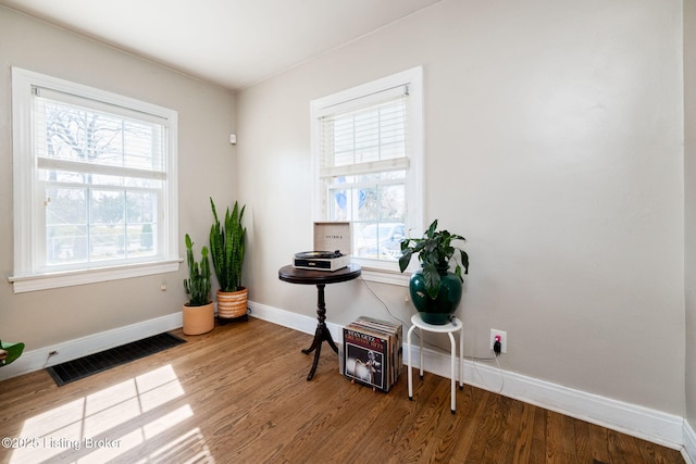 miscellaneous room featuring visible vents, baseboards, and wood finished floors