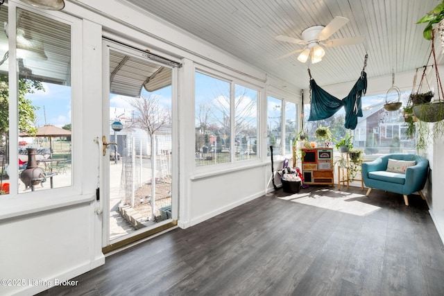 sunroom / solarium featuring a healthy amount of sunlight and a ceiling fan