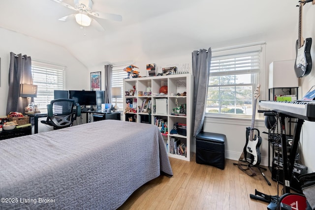 bedroom with wood-type flooring, lofted ceiling, and ceiling fan