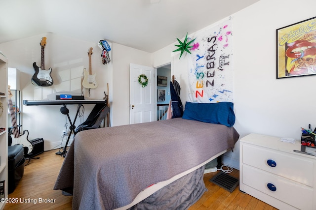 bedroom with wood finished floors