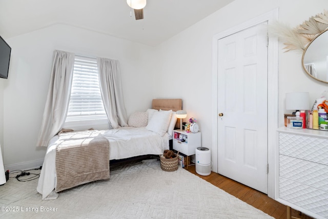 bedroom with lofted ceiling, ceiling fan, and wood finished floors