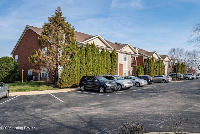 uncovered parking lot with a residential view