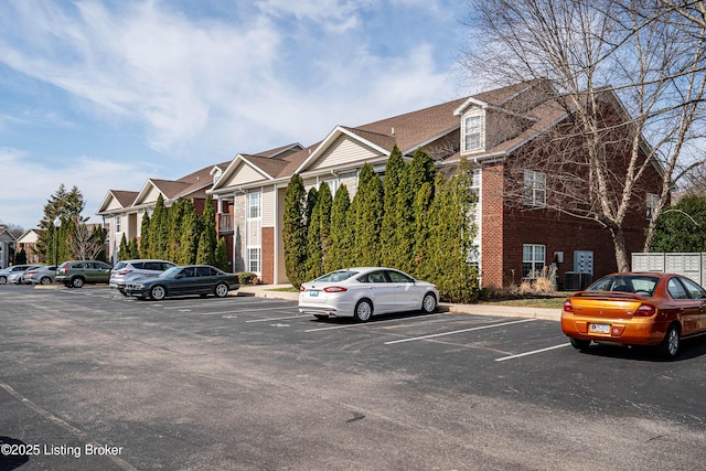 view of property featuring a residential view and uncovered parking