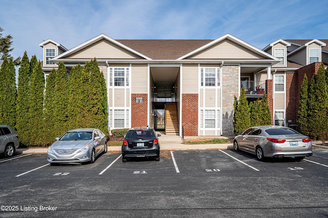 exterior space with stairs and uncovered parking