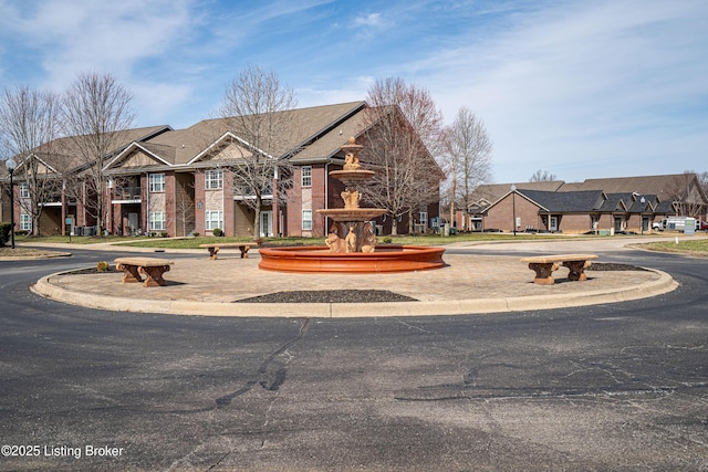 view of front of house with brick siding and a residential view