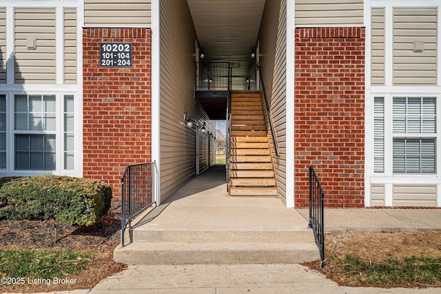 property entrance featuring brick siding