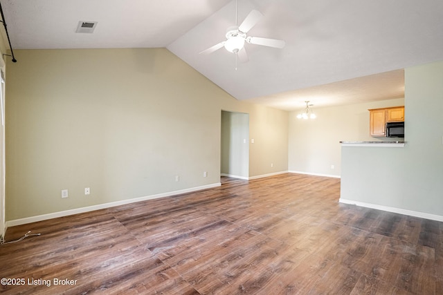 unfurnished living room with visible vents, ceiling fan with notable chandelier, baseboards, and wood finished floors