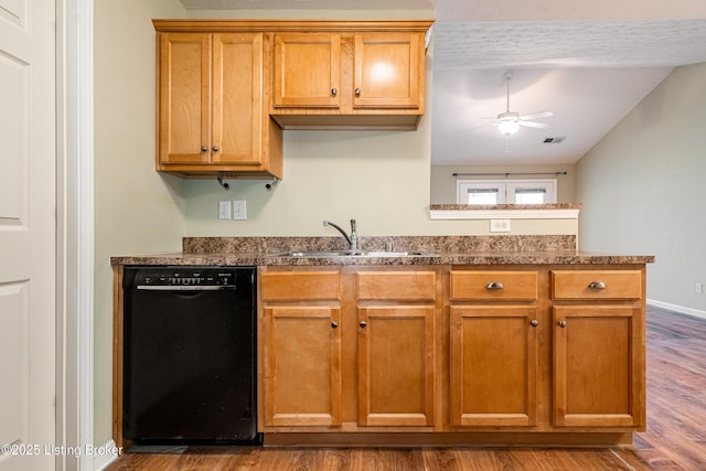 kitchen featuring visible vents, ceiling fan, dishwasher, wood finished floors, and a sink