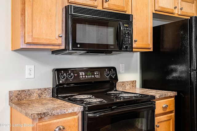 kitchen with black appliances and light countertops