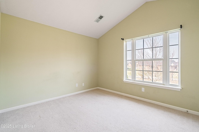 unfurnished room with vaulted ceiling, baseboards, visible vents, and light carpet