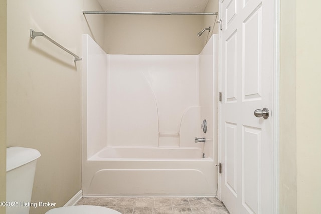 bathroom with shower / washtub combination and toilet