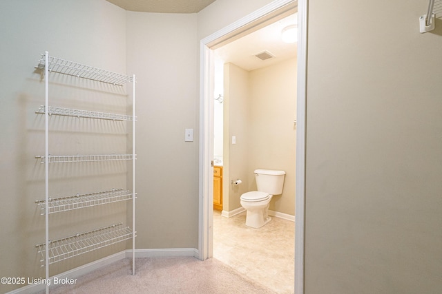 bathroom with visible vents, baseboards, and toilet