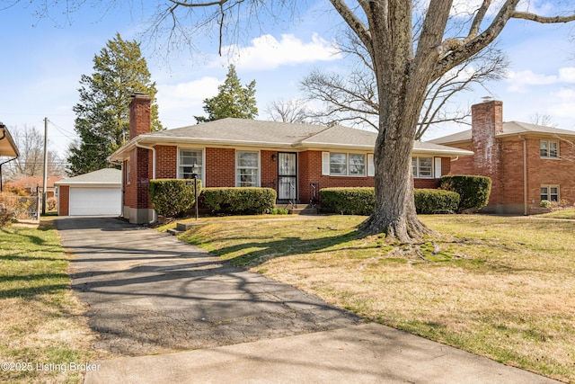 view of front of home featuring a front lawn, a detached garage, an outdoor structure, brick siding, and a chimney