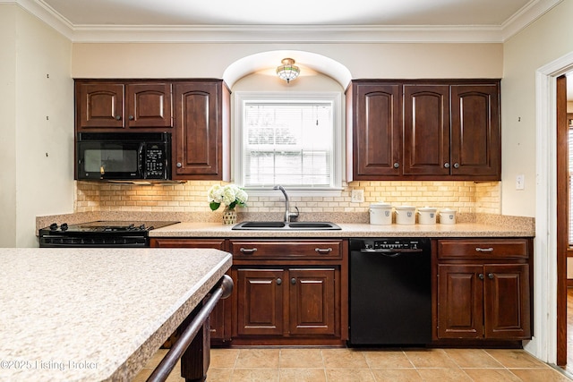 kitchen featuring decorative backsplash, black appliances, light countertops, and a sink