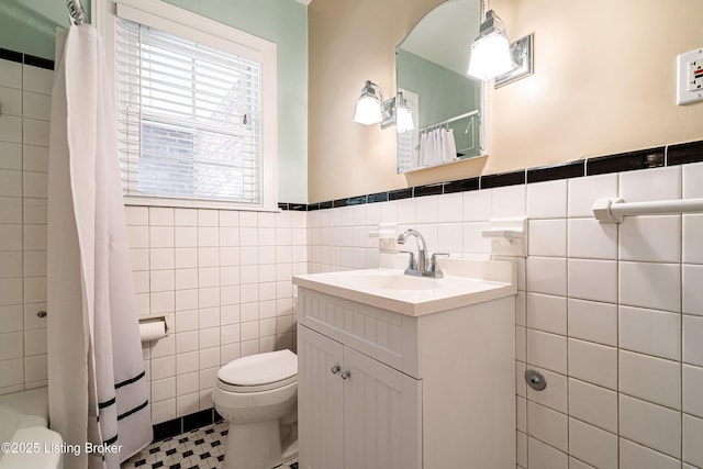 full bathroom with a shower with shower curtain, tile walls, toilet, and vanity