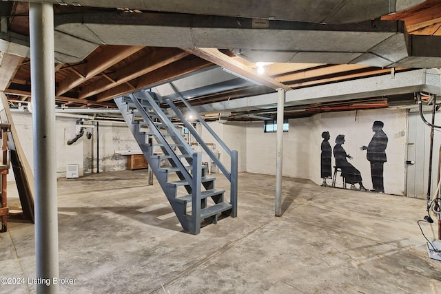 unfinished basement featuring stairway