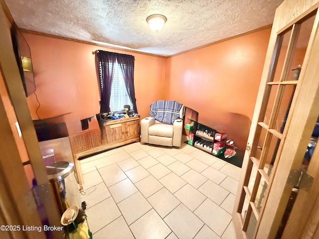 living area featuring a textured ceiling and ornamental molding