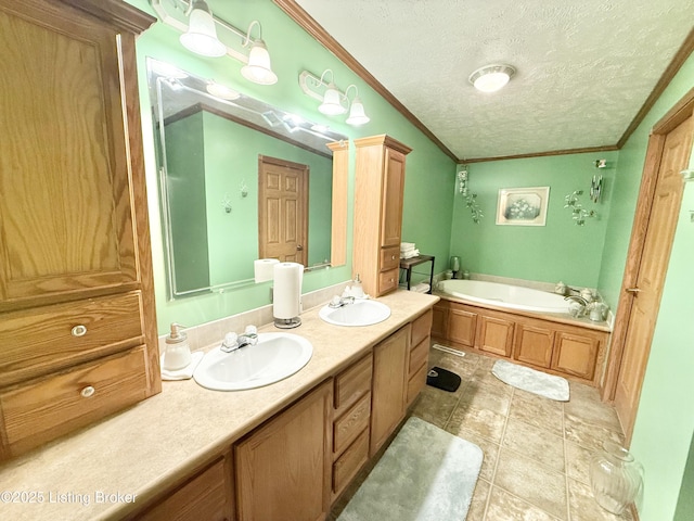 bathroom with a textured ceiling, crown molding, and a sink