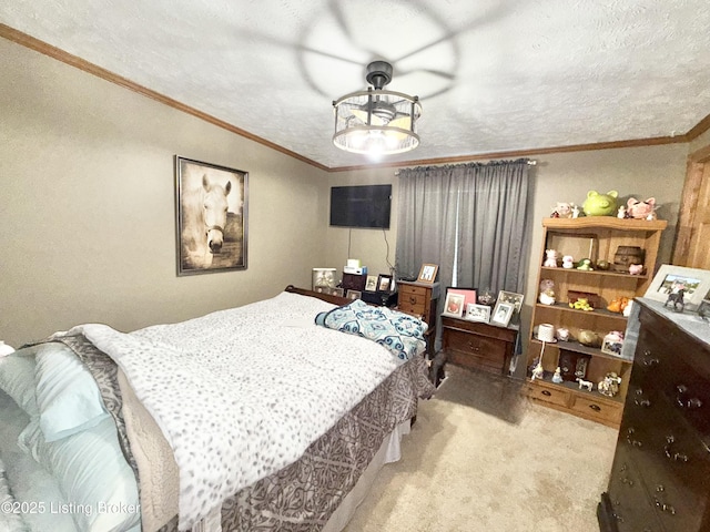 bedroom with ornamental molding, a textured ceiling, and carpet floors