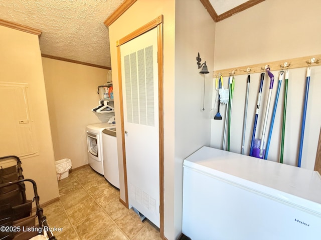 washroom featuring laundry area, washer and dryer, a textured ceiling, and crown molding