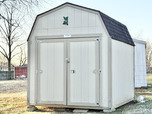 view of shed with fence