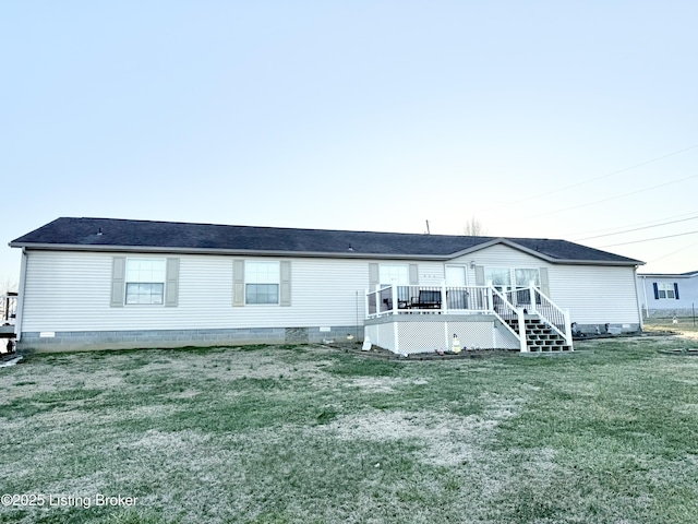 back of house featuring crawl space, a lawn, and a deck