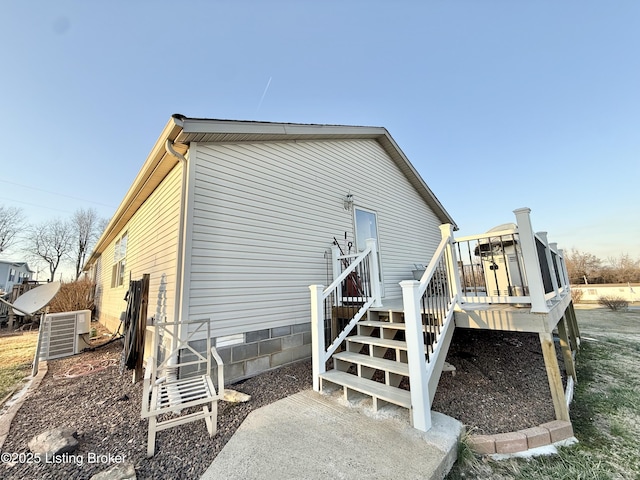 rear view of house featuring crawl space and a deck