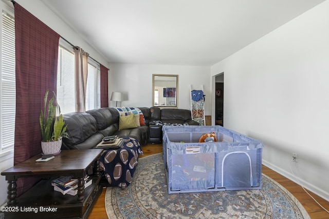 living room featuring baseboards and wood finished floors