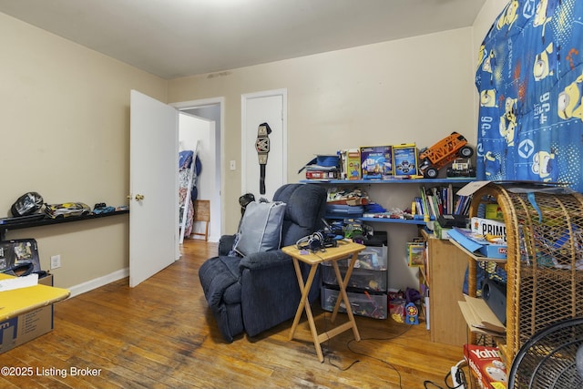 interior space featuring baseboards and hardwood / wood-style flooring