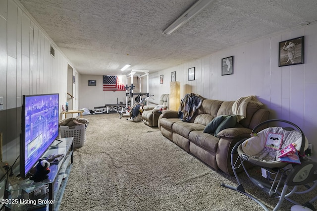 carpeted living room featuring a textured ceiling