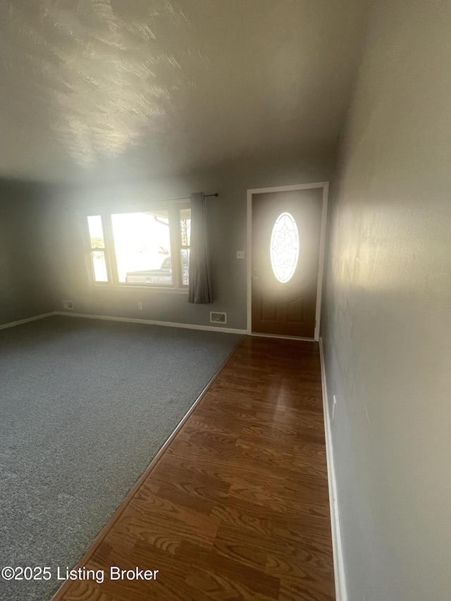 interior space featuring wood finished floors and baseboards