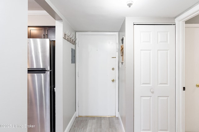 hall featuring baseboards and light wood finished floors