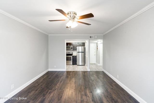 unfurnished living room with visible vents, baseboards, wood finished floors, and crown molding