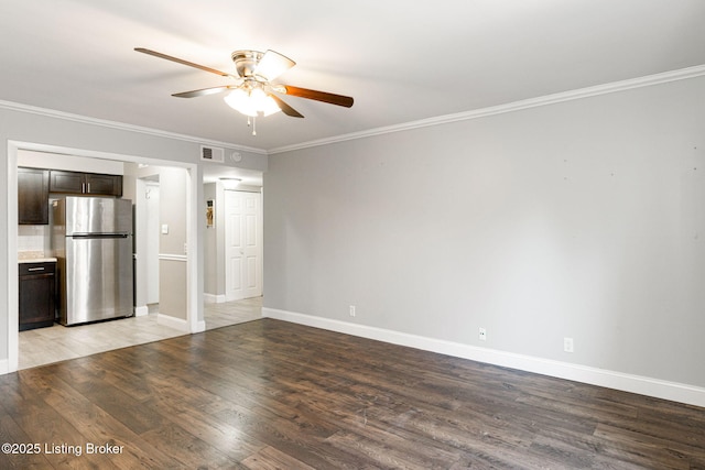 interior space with visible vents, baseboards, light wood-style floors, and crown molding