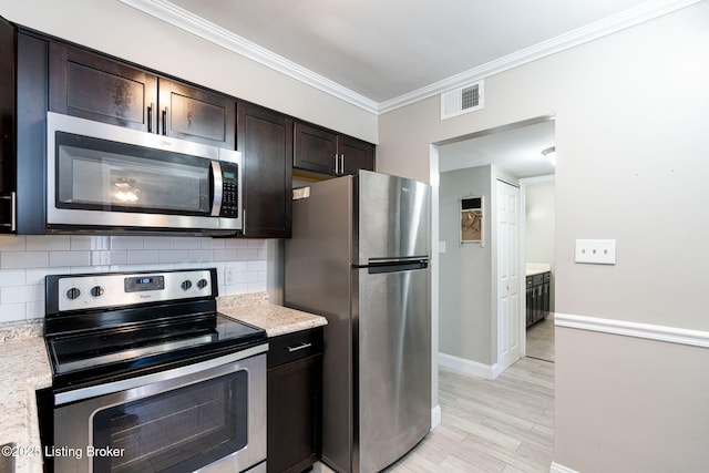 kitchen featuring visible vents, appliances with stainless steel finishes, crown molding, and decorative backsplash