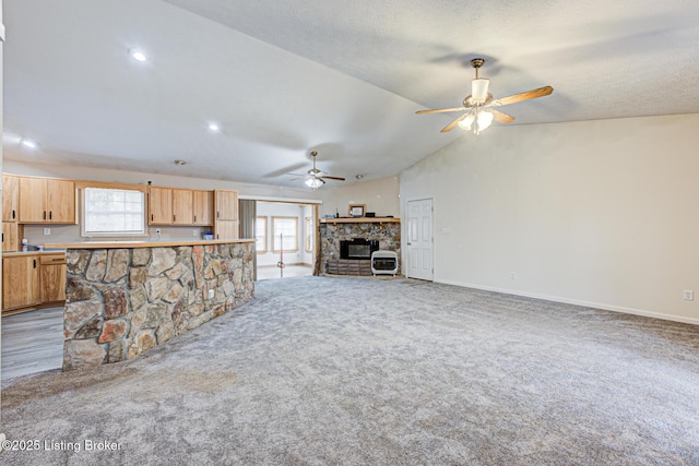 1670 Pine Creek Trl, Shepherdsville, KY 40165 - unfurnished living room with lofted ceiling, carpet floors, a stone fireplace, baseboards, and ceiling fan