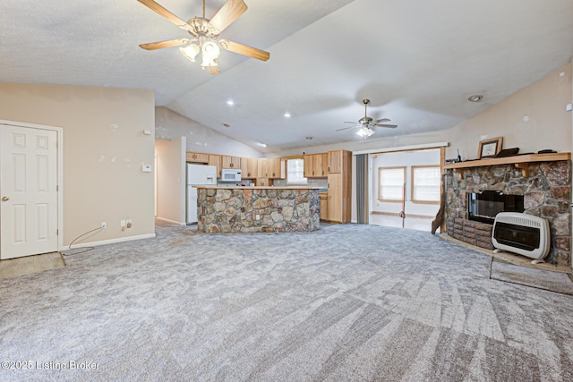 1670 Pine Creek Trl, Shepherdsville, KY 40165 - unfurnished living room featuring vaulted ceiling, light carpet, a stone fireplace, heating unit, and a ceiling fan