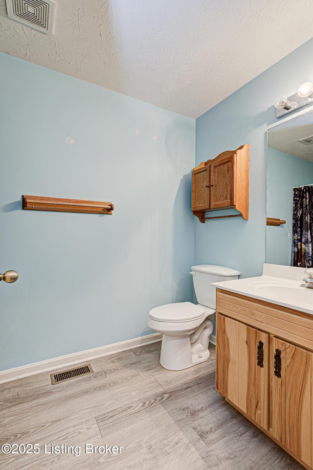 1670 Pine Creek Trl, Shepherdsville, KY 40165 - bathroom with visible vents, toilet, vanity, and wood finished floors