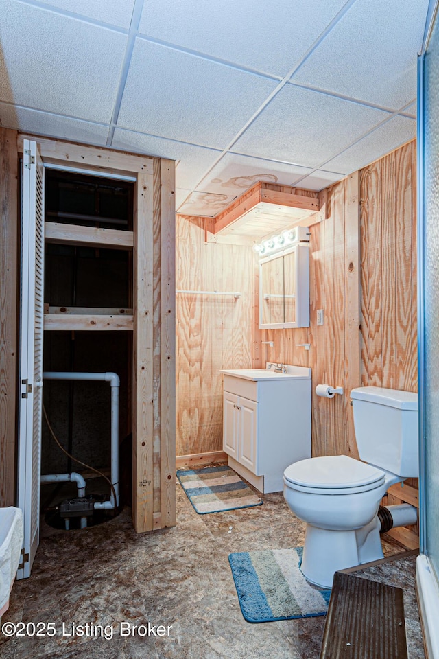 1670 Pine Creek Trl, Shepherdsville, KY 40165 - bathroom featuring wooden walls, toilet, vanity, and a drop ceiling