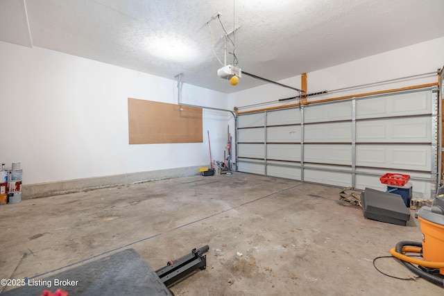 garage featuring a garage door opener and baseboards