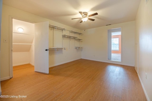 interior space featuring light wood-style floors, visible vents, a closet, and baseboards