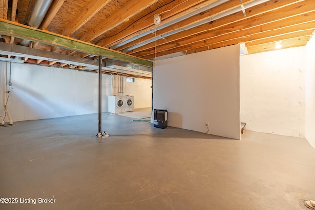 unfinished basement featuring washer and clothes dryer