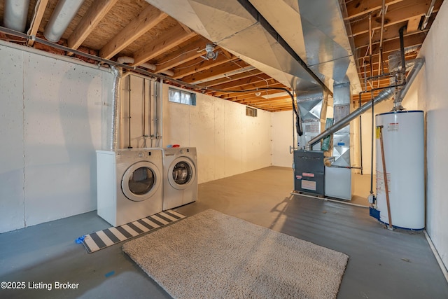 below grade area featuring gas water heater, visible vents, heating unit, and washer and dryer