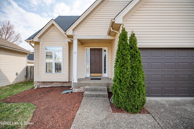 property entrance with concrete driveway and roof with shingles